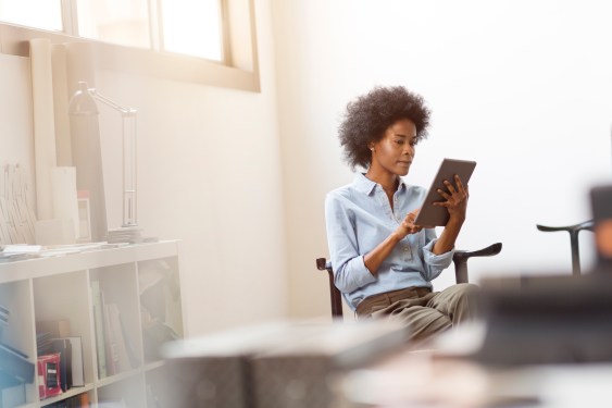 Young businesswoman using digital tablet in office