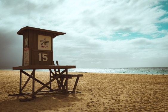 Newport Beach Lifeguard Station #15 on an empty beach with a blue sky