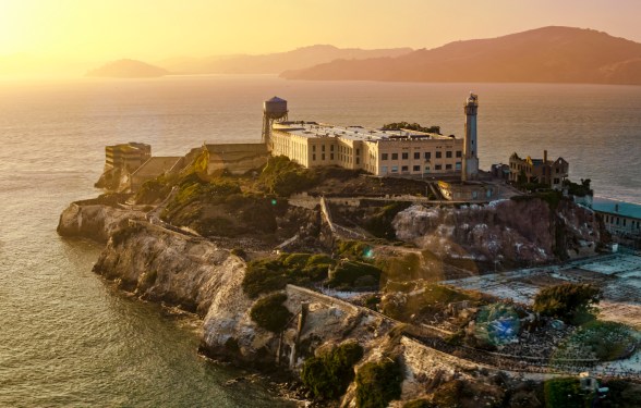 Aerial view of prison building on Alcatraz Island during sunset, San Francisco Bay, California, USA.