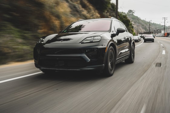 A black prototype of the new all electric Porsche Macan on a road