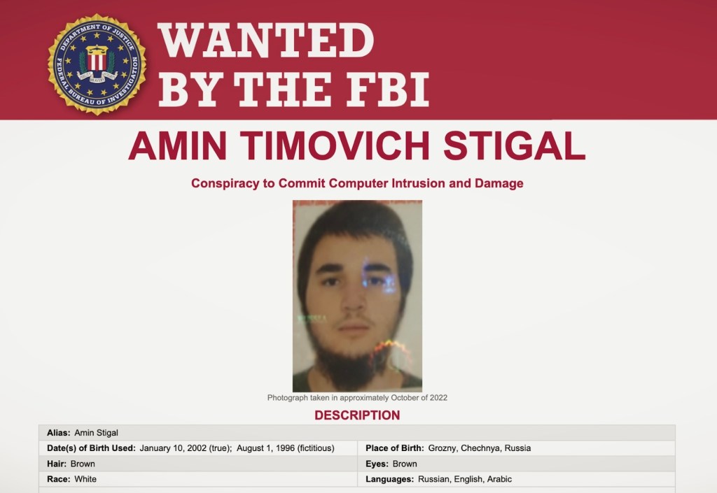 a screenshot of the FBI's wanted poster of AMIN STIGAL, a Russian man accused of conspiracy to hack Ukrainian government systems.