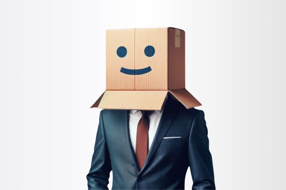 Man in suit with smiley-face box covering head