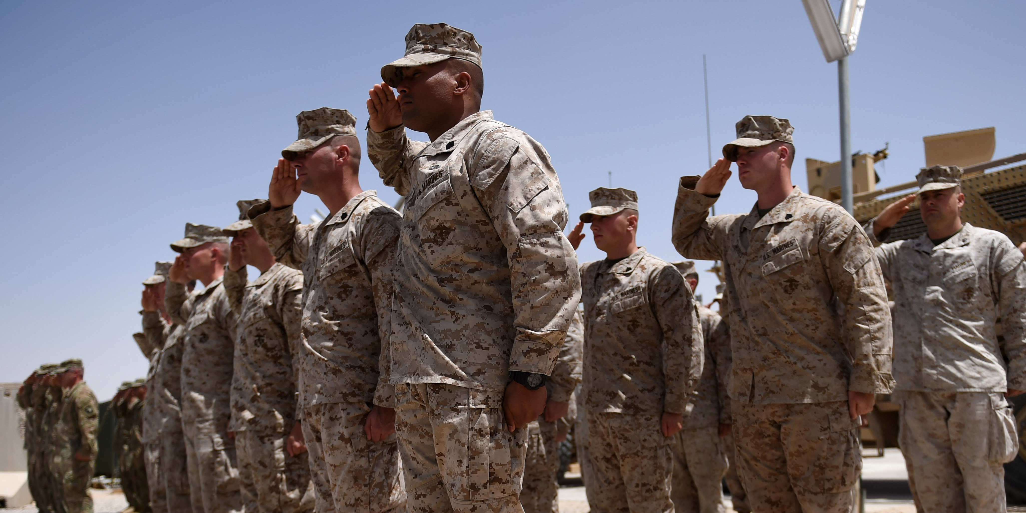 US Marines salute during a handover ceremony at Leatherneck Camp in Lashkar Gah in the Afghan province of Helmand on April 29, 2017.US Marines returned to Afghanistan's volatile Helmand April 29, where American troops faced heated fighting until NATO's combat mission ended in 2014, as embattled Afghan security forces struggle to beat back the resurgent Taliban. The deployment of some 300 Marines to the poppy-growing southern province came one day after the militants announced the launch of their "spring offensive", and as the Trump administration seeks to craft a new strategy in Afghanistan. / AFP PHOTO / WAKIL KOHSAR (Photo credit should read WAKIL KOHSAR/AFP/Getty Images)