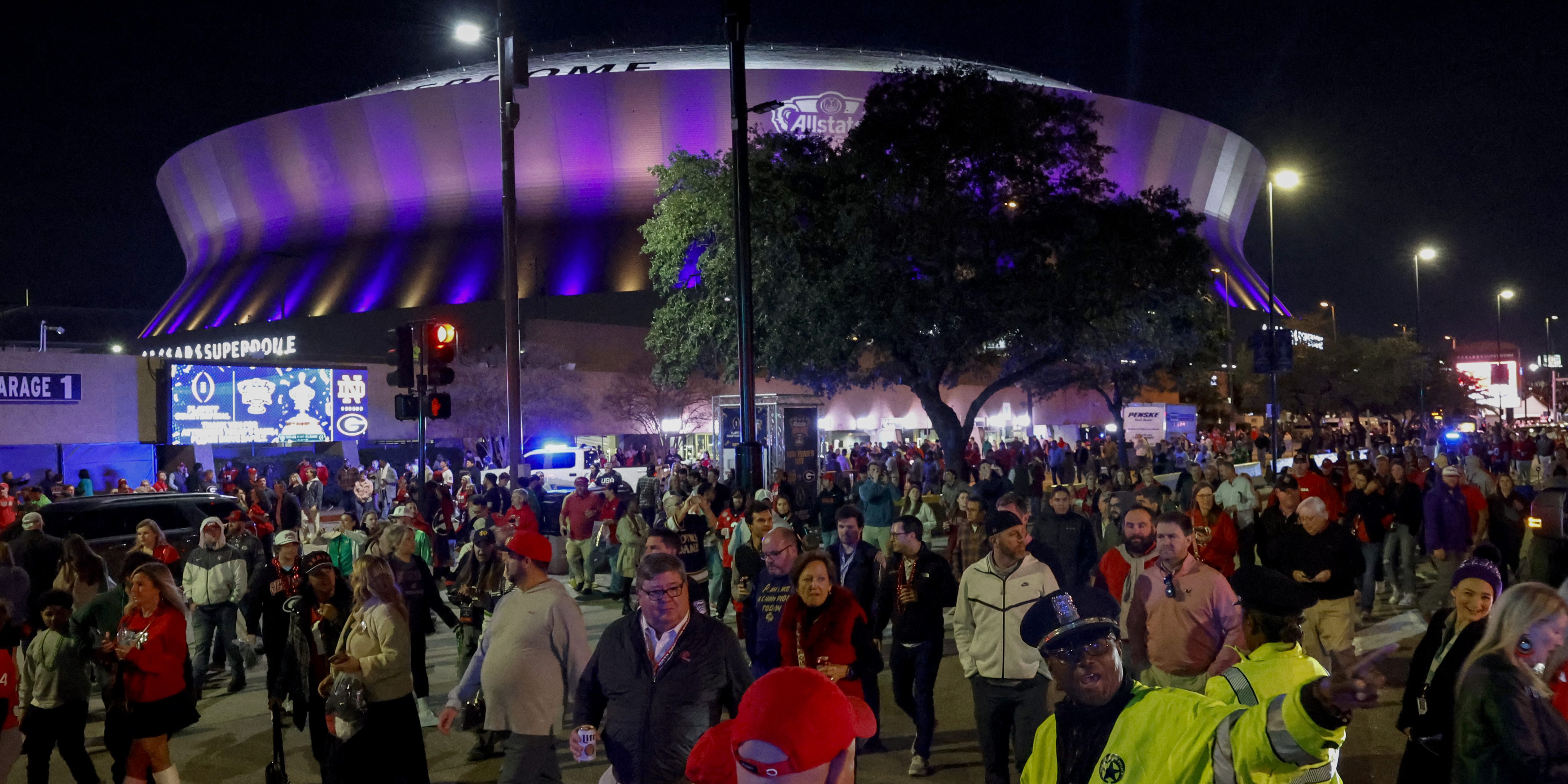 Fans leave the Caesars Superdome with a large presence of security after the Sugar Bowl NCAA College Football Playoff game, Thursday, Jan. 2, 2025, in New Orleans. (AP Photo/Butch Dill)