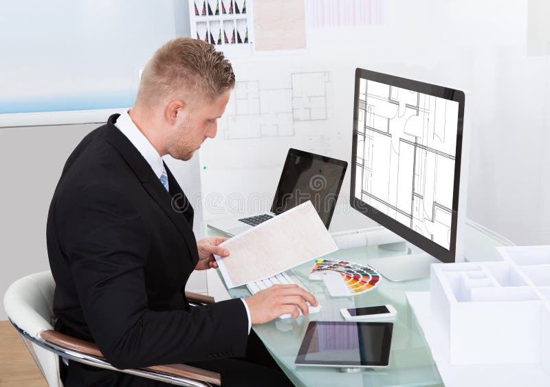 Businessman analyzing a spreadsheet online checking stock photos