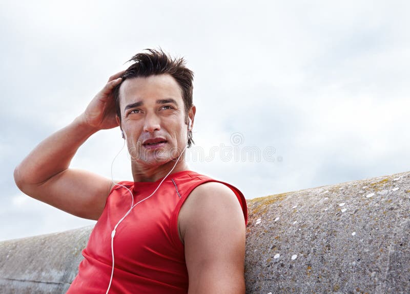 Man, break and earphones for run in outdoors, health and athlete for performance training in city. Male person, serious stock photos