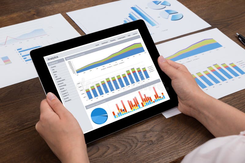 Person Analyzing Financial Statistics On Digital Tablet royalty free stock photo