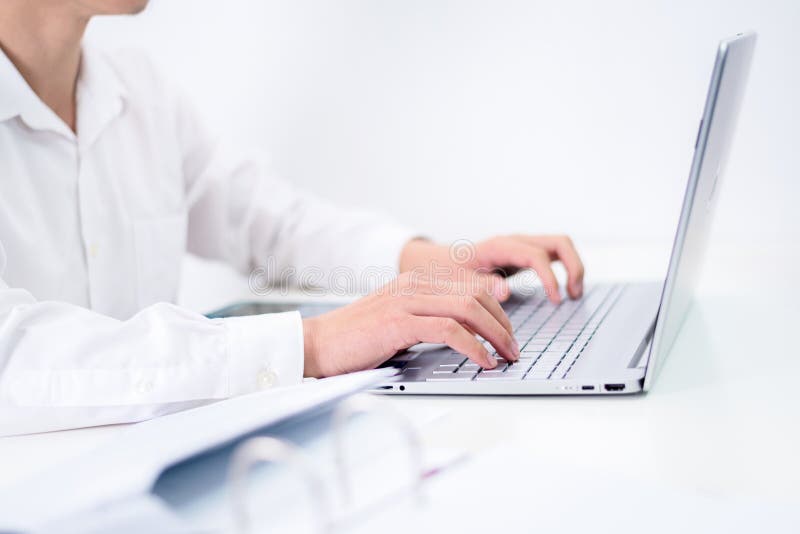 young man using laptop typing on keyboard.for writer journalist or working on computer at home. Business work from home stock images