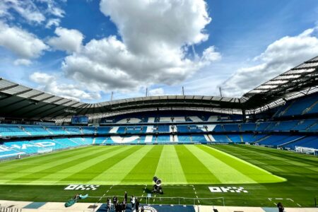 A view of the iconic Etihad Stadium in Manchester, United Kingdom, showcasing its vibrant football field.