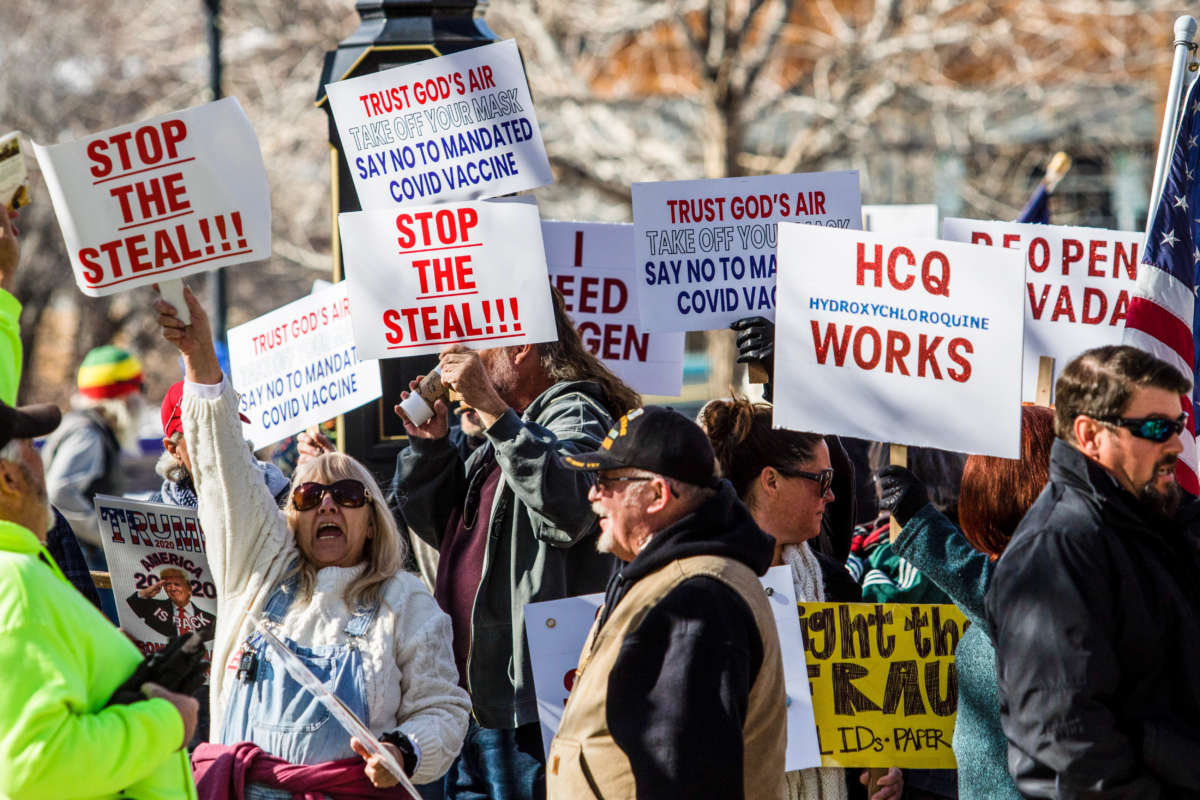 Protestors hold placards during the demonstration. Protesters gathered at the state's legislative building to protest various causes such as the Biden inauguration, COVID-19 restrictions, vaccines, and more during the first day of the 81st Session of the Nevada Legislature on February 1, 2021.