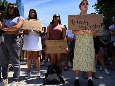 Protesters hold signs during an abortion rights demonstration at the Massachusetts State House in Boston, Massachusetts, on June 25, 2022.