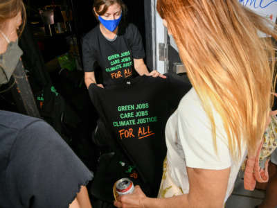 People look at t-shirts at the San Diego Green New Deal Alliance Day: Justice For Mother Earth panel on April 30, 2022, in San Diego, California.