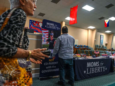 People and members of the Moms For Liberty group attend a campaign event for Jacqueline Rosario in Vero Beach, Florida, on October 16, 2022.