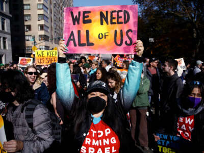 A detractor of president-elect Donald Trump protests against his policies in New York City on November 9, 2024.