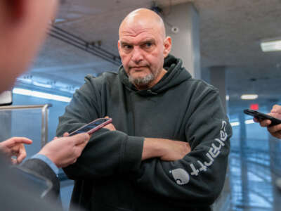 Sen. John Fetterman speaks to reporters as he goes to vote on the Laken Riley Act, which he co-sponsored, at the U.S. Capitol in Washington, D.C., on January 9, 2025.