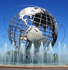 On a sunny day, in a pool with a fountains, sits a huge, skeletal representation of Earth, with North and South America visible.