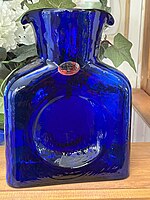 blue square-ish bottle with two spouts