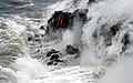 smooth lava spills into the ocean, forming new rock