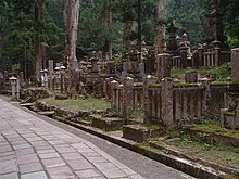 A number of vertical stone gravestones