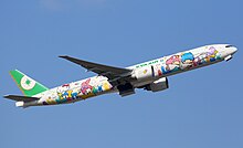 Side view of aircraft in flight; fuselage painted with Sanrio characters' faces.