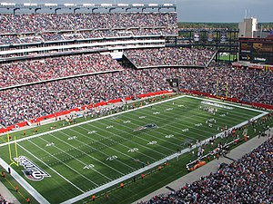 A full stadium with an open roof