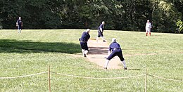 Men playing baseball in vintage uniforms