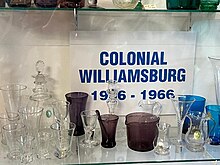 display of Colonial Williamsburg glassware in clear, dark purple, and blue