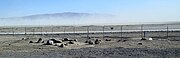 A dust storm forms over the dry Searles Lake bed, viewed from the Trona tourist stop.