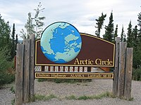 A sign along the Dalton Highway marking the location of the Arctic Circle in Alaska, United States