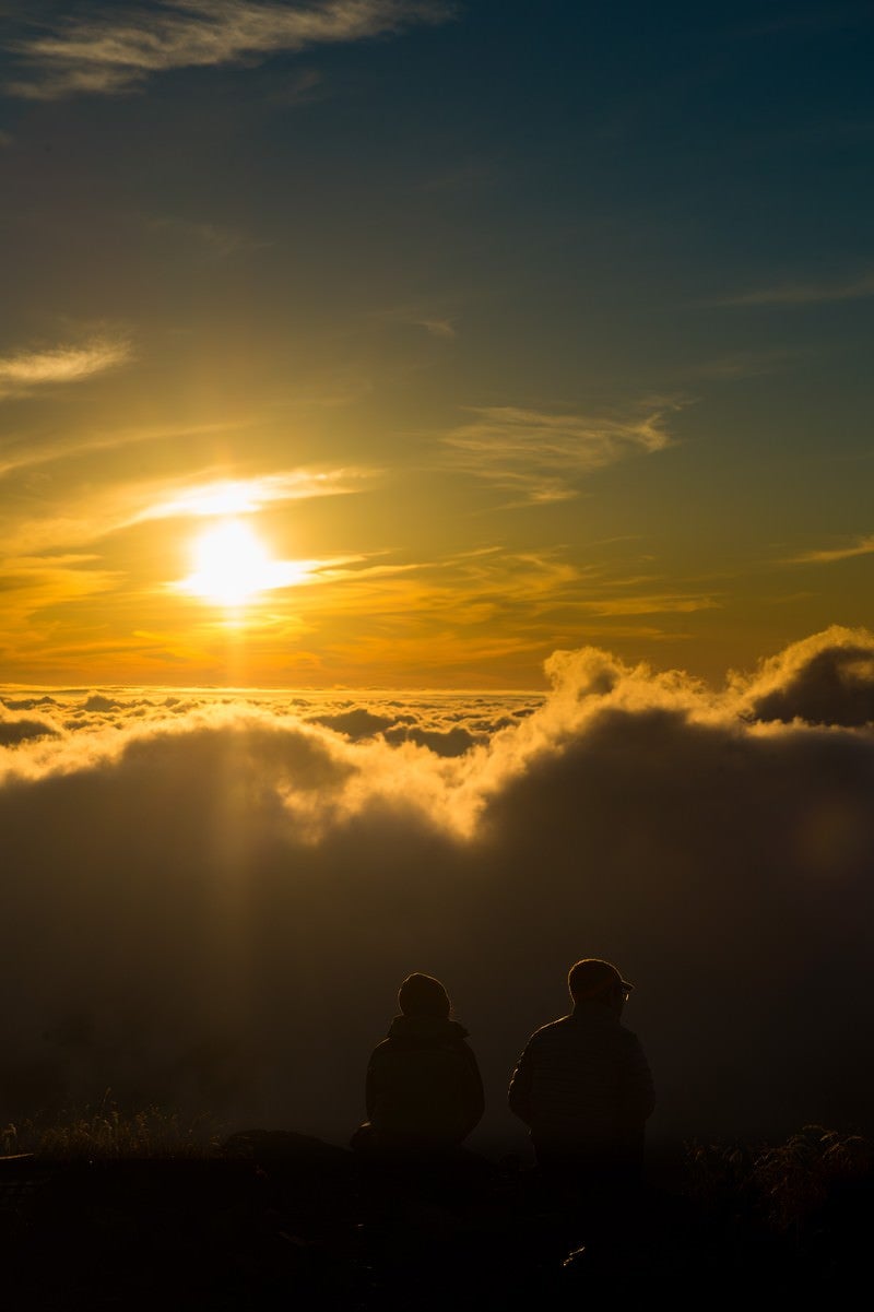 北アルプスの自然の美しさに言葉を失う登山者カップルの写真