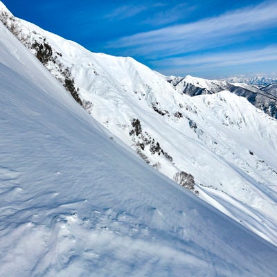 雪と岩に彩られた谷川岳の斜面の写真