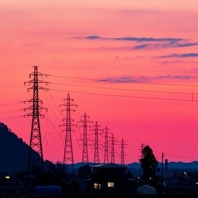 夕暮れの焼けた空と鉄塔の写真