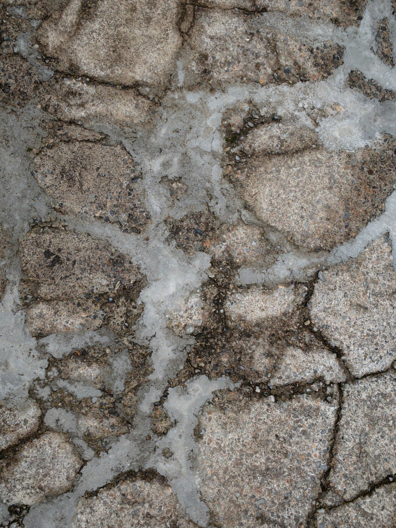 セメントで補修された地面（テクスチャー）の写真