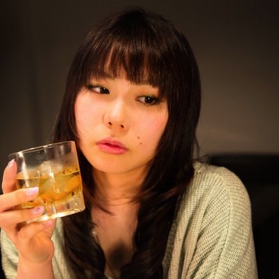 「最近疲れちゃったなー」とお酒を飲む女性の写真