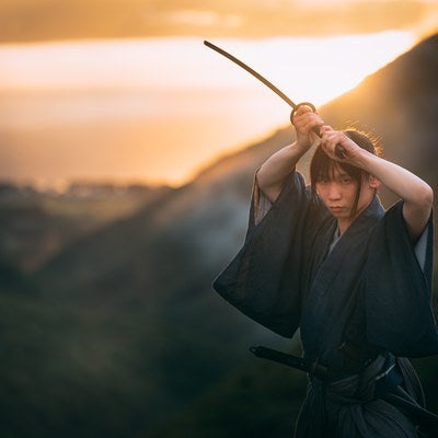 夕日を背に上段の構えをとる侍の写真