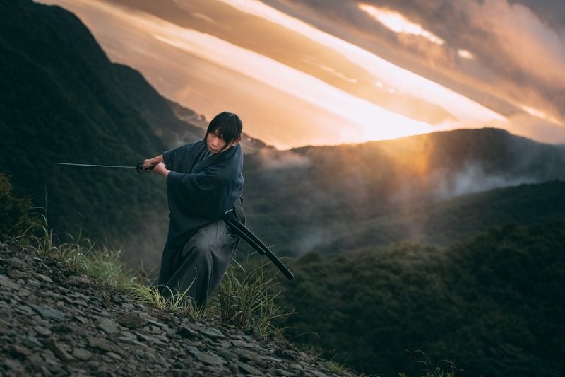 刀を振り下ろした侍と夕焼けの写真