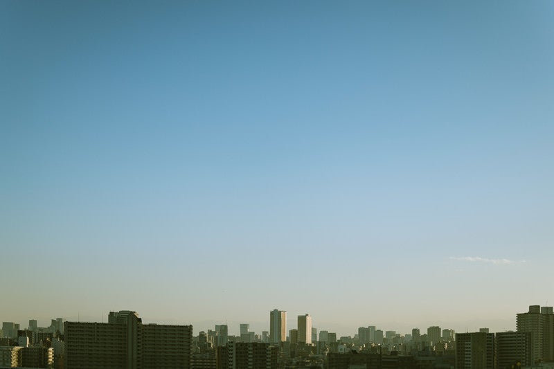 都会のマンション群と朝焼けの写真