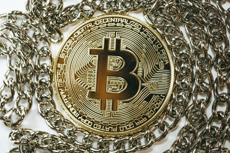 チェーンの中心にあるビットコイン（仮想通貨）の写真