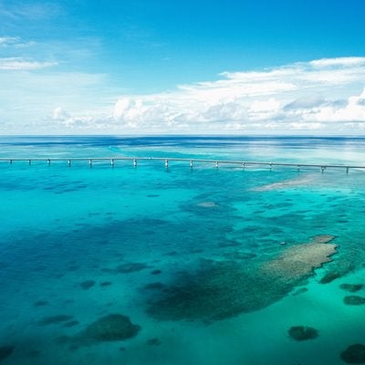 どこ間までも続く水平線と伊良部大橋の写真