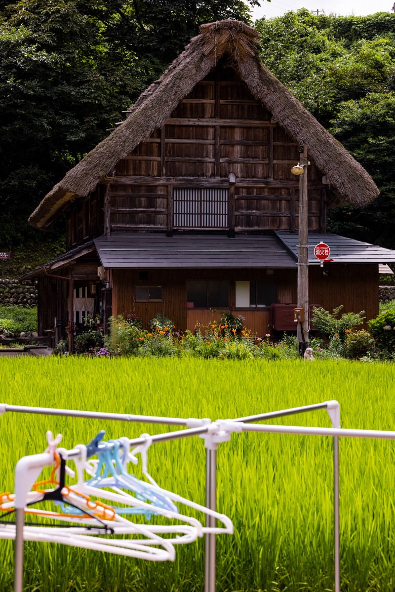 「田舎の風景（物干し台と合掌造りの家）」の写真