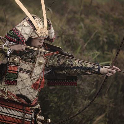 大弓で獲物を追う武士の写真