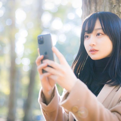 木漏れ日スマホ女子の写真