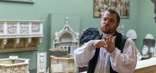 a person signs in British Sign Language in V&A South Kensington museum