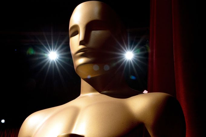 An Oscar statue stands as preparations are made along the red carpet ahead of the 95th Academy Awards, in Hollywood, California, on March 12, 2023. - The red carpet for the Oscars airing on March 12, 2023, is champagne-color for 2023. (Photo by Stefani Reynolds / AFP) (Photo by STEFANI REYNOLDS/AFP via Getty Images)