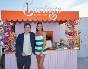 B.J. Novak and Chrissy Teigen smile for the cameras at The Infatuation’s EEEEEATSCON Los Angeles presented by Chase Sapphire at the Barker Hangar  on Sunday, June 9, 2024, in Los Angeles. (Casey Rodgers/The Infatuation and Chase Sapphire via AP Images)