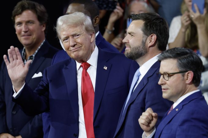 MILWAUKEE, WISCONSIN - JULY 15: (L-R) Tucker Carlson, U.S. Rep. Byron Donalds (R-FL), Republican presidential candidate, former U.S. President Donald Trump,  Republican vice presidential candidate, U.S. Sen. J.D. Vance (R-OH), and Speaker of the House Mike Johnson (R-LA) appear on the first day of the Republican National Convention at the Fiserv Forum on July 15, 2024 in Milwaukee, Wisconsin. Delegates, politicians, and the Republican faithful are in Milwaukee for the annual convention, concluding with former President Donald Trump accepting his party's presidential nomination. The RNC takes place from July 15-18. (Photo by Chip Somodevilla/Getty Images)