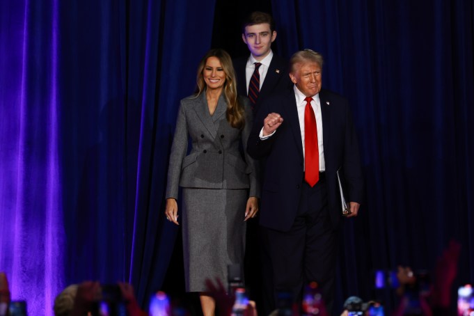 WEST PALM BEACH, FLORIDA - NOVEMBER 06:  Republican presidential nominee, former U.S. President Donald Trump arrives to speak with former first lady Melania Trump and Barron Trump during an election night event at the Palm Beach Convention Center on November 06, 2024 in West Palm Beach, Florida. Americans cast their ballots today in the presidential race between Republican nominee former President Donald Trump and Vice President Kamala Harris, as well as multiple state elections that will determine the balance of power in Congress.   (Photo by Joe Raedle/Getty Images)