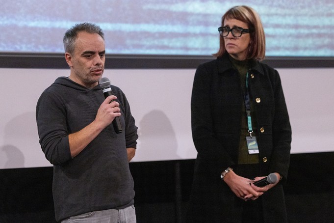 US film director Joel Souza (L) and cinematographer Bianca Cline (R) stand on stage before the first screening of the "Rust" movie at the Camerimage film festival in Torun, Poland, on November 20, 2024. The Western "Rust" will get its world premiere on November 20, 2024 at the Polish film festival, three years on from a shock on-set shooting that killed the cinematographer. Hollywood A-lister Alec Baldwin was accused of violating basic gun safety rules in the 2021 death of Halyna Hutchins, but his involuntary manslaughter trial was dismissed over withheld evidence earlier this year. Director Joel Souza, who was wounded in the shooting, will introduce the movie at the Camerimage film festival -- known for celebrating cinematography -- in Torun, northern Poland. (Photo by Wojtek RADWANSKI / AFP) (Photo by WOJTEK RADWANSKI/AFP via Getty Images)