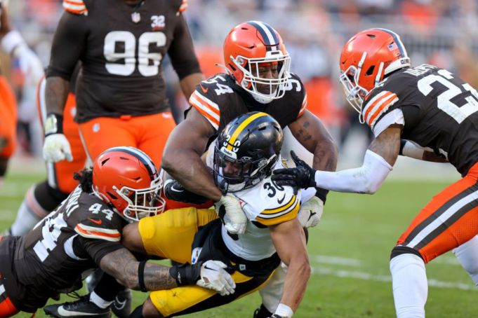 CLEVELAND, OH - NOVEMBER 19: Pittsburgh Steelers running back Jaylen Warren (30) is tackled y Cleveland Browns linebacker Sione Takitaki (44) and Cleveland Browns defensive end Ogbo Okoronkwo (54) during the third quarter of the National Football League game between the Pittsburgh Steelers and Cleveland Browns on November 19, 2023, at Cleveland Browns Stadium in Cleveland, OH. (Photo by Frank Jansky/Icon Sportswire via Getty Images)