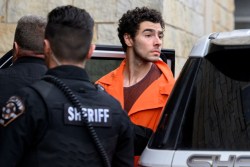 HOLLIDAYSBURG, PENNSYLVANIA - DECEMBER 10: Suspected shooter Luigi Mangione is led into the Blair County Courthouse for an extradition hearing December 10, 2024 in Hollidaysburg, Pennsylvania. Mangione has been arraigned on weapons and false identification charges related to the fatal shooting of United Healthcare CEO Brian Thompson in New York City. Mangione is incarcerated in the State Correctional Institution in Huntingdon, Pennsylvania awaiting extradition to New York.